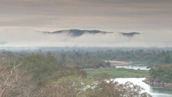 Low clouds churn over a river valley. Stock Footage