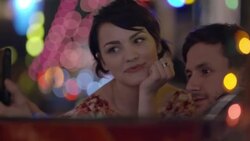 Young couple pose for smartphone selfies in colorful Austin bar Stock Footage