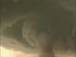 WA large swirling tornado crossing road, on horizon, tilt up to clouds and tilt down to tornado again, USA Stock Footage