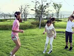 MS SLO MO Shot of One boy and two girls doing jump rope / Seoul, South Korea Stock Footage