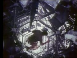 Astronaut moving thru metal frames in zero gravity Stock Footage