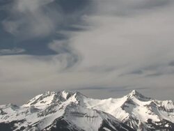 MS View of Clouds and Snow Rolling over Majestic Mountain Peaks in evening Light / Telluride, Colorado, United States Stock Footage
