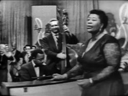 B/W 1955 Ella Fitzgerald singing with band / audience in background / The Larry Finley Show Stock Footage