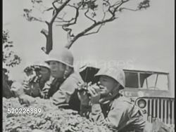 1945: OKINAWA, JAPAN: HA WS Artillery explosions on small hill. General Simon Bolivar Buckner, Jr. (1886-1945) watching battlefield w/ binoculars. WS Artillery shells exploding. WS Artillery fire on tank in open field. Pacific Theater, WWII Instructional Video