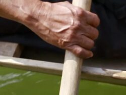 CU TD SLO MO Shot of Hand of man holding paddle and rowing / Ou river, Luang Prabang, Laos Stock Footage