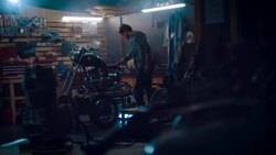 Man in motorcycle workshop building a bike Stock Footage