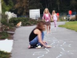 WS  A barefoot girl hopscotching  running on sidewalk / Langley, British Columbia, Canada. Stock Footage