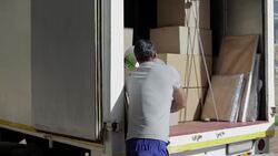 Man removing cardboard box from moving truck Stock Footage