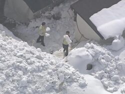 MS AERIAL Shot of People removing snow on roof / Gangneung, Gangwon do, South Korea Stock Footage