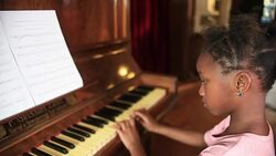 Young girl playing Piano Stock Footage
