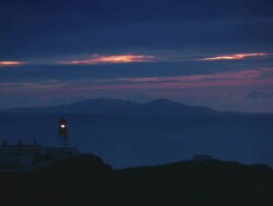 WS T/L View of colorful sunrise over point lighthouse with clouds / Skye Island, Scotland, United Kingdom Stock Footage