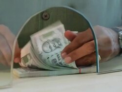 Adult man counting money at bank counter, Delhi, India Stock Footage