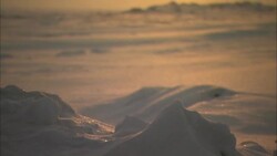 The sun glows in a yellow sky over the Alaskan tundra. Stock Footage