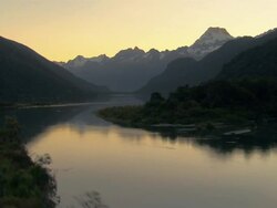 LOW AERIAL, River and mountains at sunset, Fiordland National Park, New Zealand Stock Footage