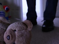 Teddy bear, man leaving dark room. Stock Footage
