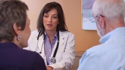 Female Healthcare Professional Talks with Senior Couple Stock Footage