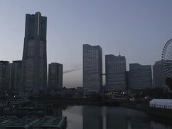 Light-up of the Skyline of Minato Mirai 21 with Cosmo World Ferries Wheel, Yokohama, Japan Stock Footage