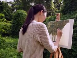 MS woman painting on an easel outdoors. Stock Footage