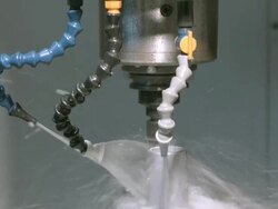 CU computer controlled sled moves metal work piece inside electronic milling machine while precision holes are drilled from above and cooled by continuous spray of water / Redlands, California, USA Stock Footage