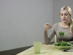 Bored woman with bowl of salad Stock Footage