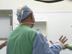 Doctors in surgery room preparing themselves Stock Footage
