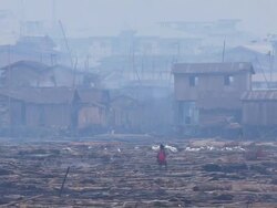 WS Boy with net walking on logs / Lagos, Nigeria Stock Footage
