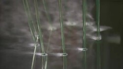 Steam rises from a cooling bath where plastic trimming line runs through. Stock Footage