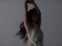 two woman laying on ground with there legs up draped with red silk around them Stock Footage