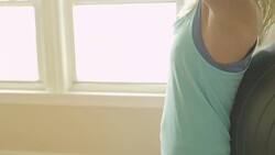 A mature woman uses an exercise ball in her home gym. Stock Footage