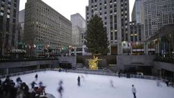 Tourists enjoy ice skating in Rockefeller Plaza. Stock Footage
