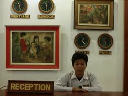 MS Shot of hotel reception attendees standing behind desk / Vientiane, Laos Stock Footage
