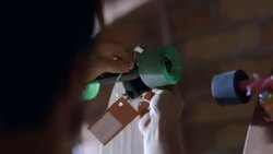 Shop worker ties price tag around skateboard wheel Stock Footage