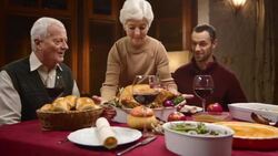 Grandmother presenting the Thanksgiving turkey to her family Stock Footage