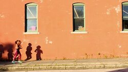 MS Group of women running on sidewalk of city street at sunrise Stock Footage