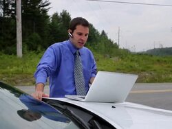 MS Man outside car in rural area while talking on bluetooth / Portland, ME, United States Stock Footage