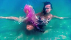 Caucasian woman in dress swimming under water Stock Footage