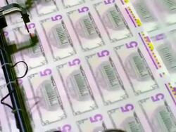 ECU, Sheets of American five dollar bills moving fast on conveyor, Washington DC, USA Stock Footage