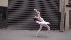 Ballerina taking selfie doing backbend in urban alley Stock Footage