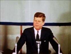 1963 President John Kennedy at podium making speech to US Navy / industrial Stock Footage