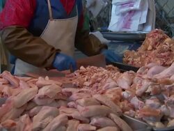 Butcher working in a Beijing meat market News Clip
