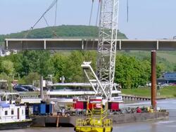 WS Passing Shot of Crane moving ahead with Mosel river, deconstruction of bridge / Wellen, Rhineland Palatinate, Germany Stock Footage
