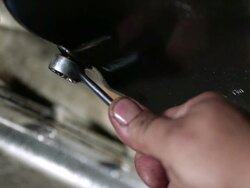 CU Mechanics tightening nut with wrench on oil pan / Bergenfield, , New Jersey, USA    Stock Footage