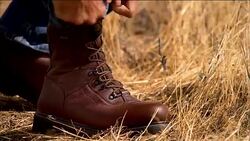 Close up hunting boot and a man ties the laces. Stock Footage