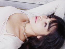 CU PAN Shot of beautiful brunette lays napping on park bench and smiles / Portland, Oregon, United States  Stock Footage