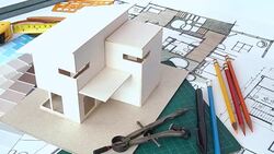 Architects workspace with house model & blue print Stock Footage
