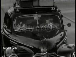 1946: U.S. VACATION: WS Two way highway, cars (outskirts of New York City). MS Americans driving in car w/ luggage on top. (POV car) Pulling into Motor Lodge Cabin parking lot, man putting up sign 'Open.' VS Driver & man talking. WS Car entering lot. Instructional Video