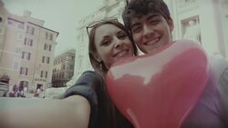 Tourist couple with heart baloon taking a selfie in Rome Stock Footage