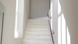 White staircase with pitcher in window Stock Footage