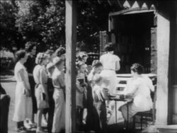 B/W 1934 women + children waiting in line to enter bookmobile on street  / newsreel Stock Footage