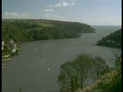T/L WA high angle view of River Dart leading out to sea, Pan left to Kingsbridge Town, Dartmouth, boats and ferries on river Stock Footage